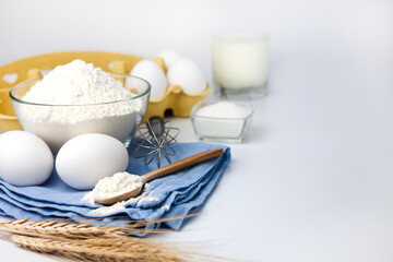 Baking process. Flour, eggs, milk and sugar on the table. Cooking process. Close-up. Copy space.