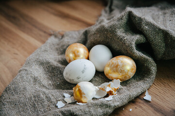 Fototapeta na wymiar golden eggs Easter wooden background