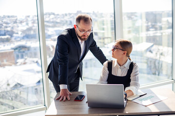 A female manager in her own office talks about a successful new business plan for economic...