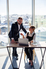 A female manager in her own office talks about a successful new business plan for economic development to her mentor teacher. Office work