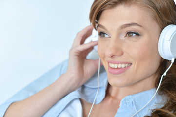 Young woman listening music with headphones