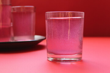 red drink of milky preparation of raspberry blueberries or kulbnik mors juice compote on a red background with a place for text and copyspace © Кристина Шоба