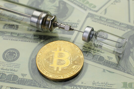 Bitcoin glass syringe and vaccine vial on american dollars background