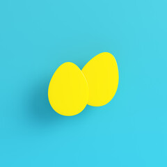 Yellow easter eggs on bright blue background in pastel colors