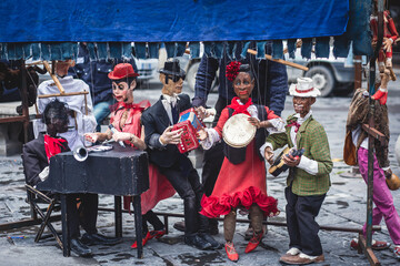 View of street puppet show theatre, with puppeteer puppet master pulling the strings over...