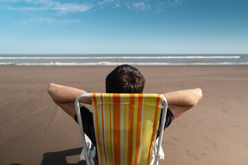 Young man relaxing on the beach on vacation