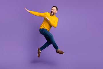 Fototapeta na wymiar Full body profile portrait of energetic man look empty space arms dabbing isolated on purple color background