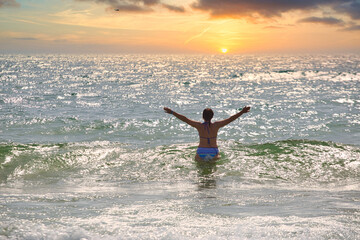 Fototapeta premium woman bathes in sea waves on the beach