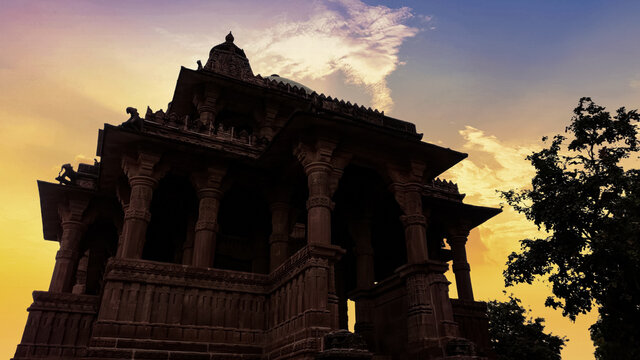 Silhouette of a temple with yellow sunset lights background