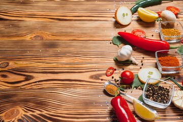 Spices and herbs over wooden background, healthy or cooking concept.