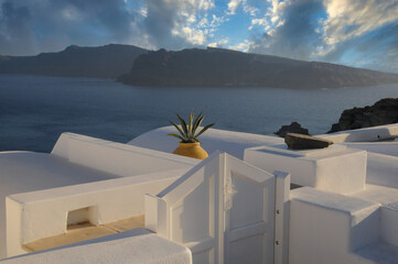Panoramic photo from the terrace of a traditional Greek house overlooking the sea and the island caldera in Oia, Santorini, Greece.Travel and tourism concept