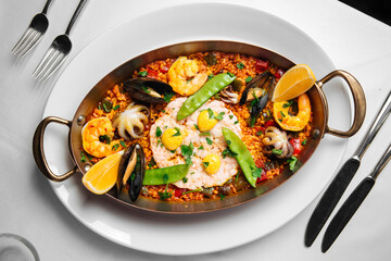 Spanish national cuisine dish paella with seafood and rice in a pan