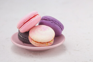 Pastel macaron on pink plate