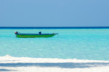 Fototapeta na wymiar vintage colorful boat on turquoise water