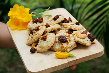 Sweets cookies on a wooden cutting board, natural background