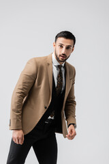 Fototapeta premium young muslim man in elegant clothes looking at camera isolated on grey