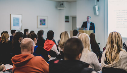 Man giving presentation in lecture hall at university.