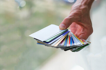 A man is hand holds a stack of discount cards. Discount card .