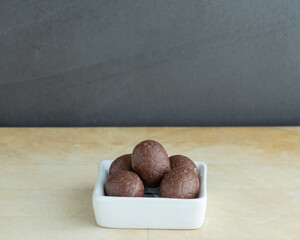 Chocolate eggs on a white little bowl