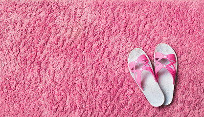 Well worn flip flop sandals on soft carpet