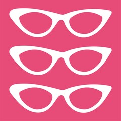 set of retro sunglasses on the pink background