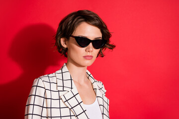 Photo of young attractive woman confident serious wear sunglasses gorgeous isolated over red color background