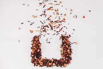 Dry fruit tea randomly scattered on a white table background. Top view. Copy, empty space for text