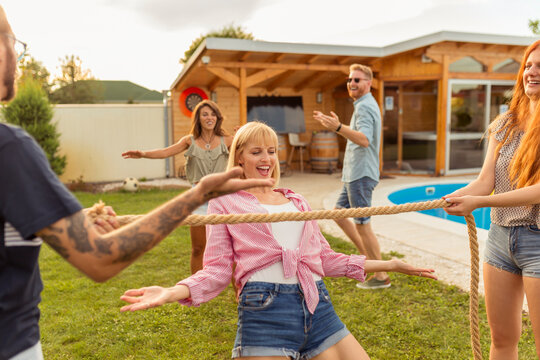 Friends Participating In Limbo Dance Contest