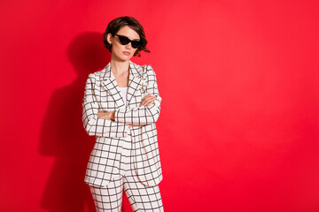 Photo of young attractive business woman confident crossed hands serious isolated over red color...