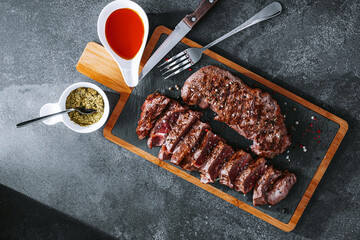 juicy fresh fried steaks for dinner. two fried striploin steak in a medium roasting rare