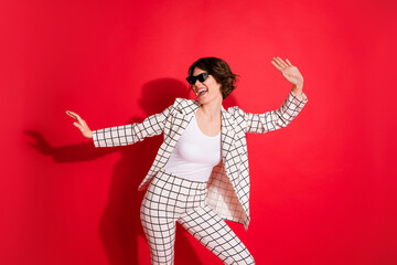 Photo of young attractive girl crazy happy smile have fun enjoy music dance party isolated over red color background