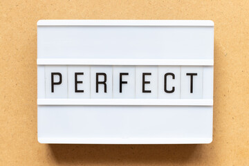Lightbox with word perfect on wood background