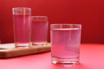 red drink of milky preparation of raspberry blueberries or kulbnik mors juice compote on a red background with a place for text and copyspace © Кристина Шоба