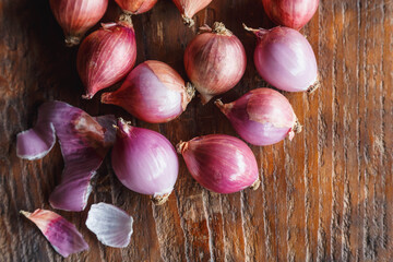 Fresh red onions on rustic wood