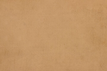 The surface of old worn brown cardboard, covered with creases and stains. Uniform light abstract texture.