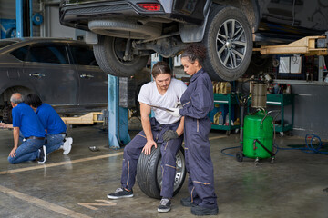 Obraz na płótnie Canvas Team of mechanic and technicians work in car service garage