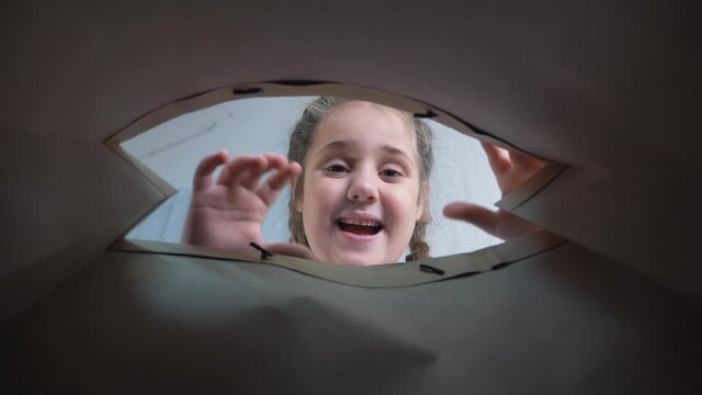 Delivery of groceries to the door. Online shopping. A little girl opens a bag of groceries. Safe delivery of groceries. Online Store. Delivery in a security mask to door. Online shopping and delivery