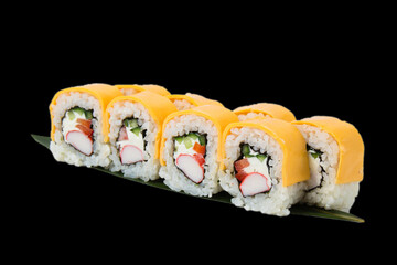 Sushi rolls with crab stick, philadelphia cheese, cucumber and red bell pepper, on black background
