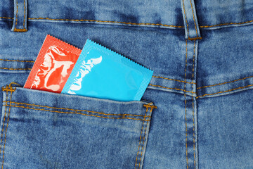 two condoms in the back pocket of blue jeans, safer sex condom.