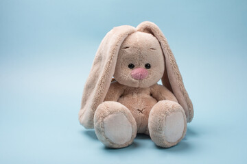 soft toy rabbit. Easter Bunny on a blue background - Powered by Adobe
