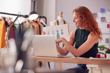 Female Business Owner Working In Fashion Showing Designs On Video Call Using Laptop