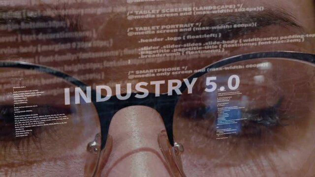 Industry 5.0 text on the background of female software developer. Eyes of woman with glasses are looking at programming code space abstract technologies connecting global data network