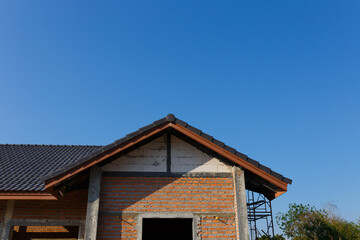 New House under construction under blue sky.