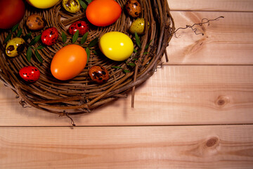 Easter eggs in a basket on wooden background