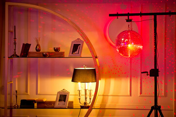 Disco ball illuminated by a bright spotlight in the interior of the restaurant.