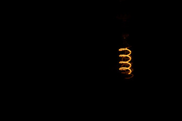 An orange bulb glowing in the dark
