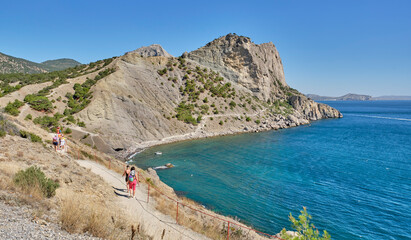 Fototapeta premium Crimean peninsula. People walk along the tourist route Golitsyn Trail. Botanical reserve New World.