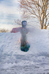 A straw effigy of Maslenitsa dressed in old Russian clothes is prepared for burning. The scarecrow is stuck in a snowdrift and begins to burn