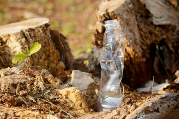 a plastic bottle lies on grass in nature like garbage