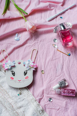 Set of Girly Things. Happy Easter Greeting card.Flower, glitter, parfume and a white bunny ears on pink background. Concept of holiday, birthday, Easter, March 8. Flat lay.
